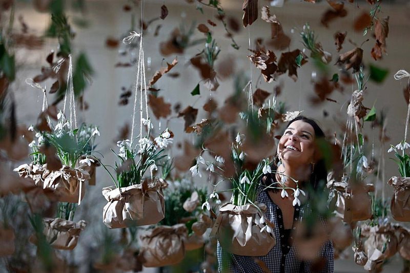 a visitor stands among the snowdrop display at the show